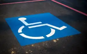 Painted accessible parking symbol on pavement