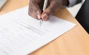 Signing a piece of paper