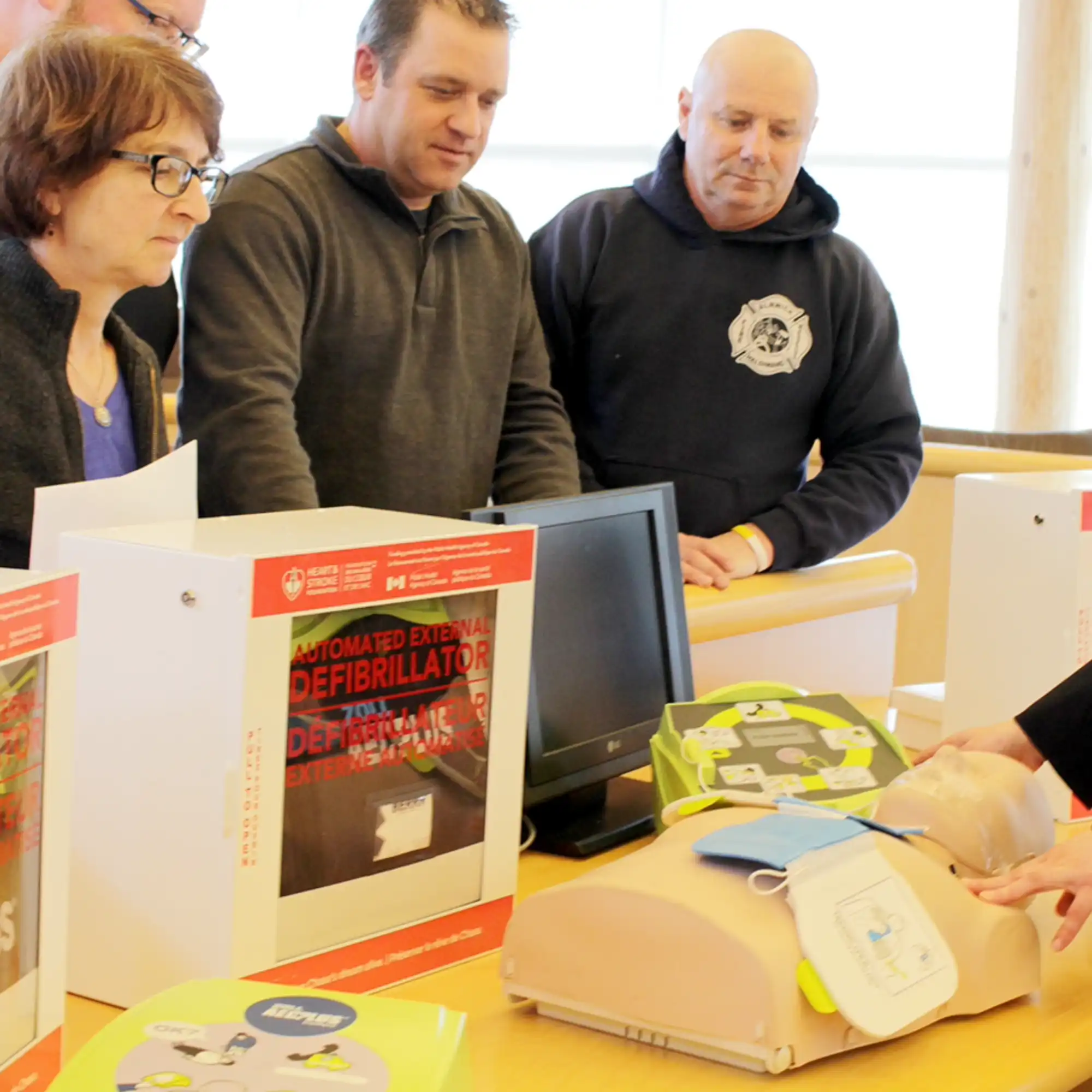 Community members receiving training on how to operate an AED. 