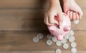 Putting change into piggy bank