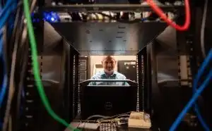 IT worker inspects a computer 