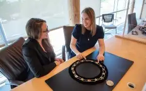Two people sitting in front of the Warden's Chain of Office 