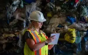 A health and safety inspector checks off items on a clipboard