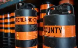 Two orange pylons with the words Northumberland County on them 