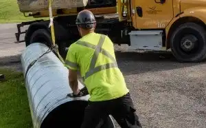 A construction worker installs a piece of equipment 