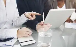 Three people looking at tablet